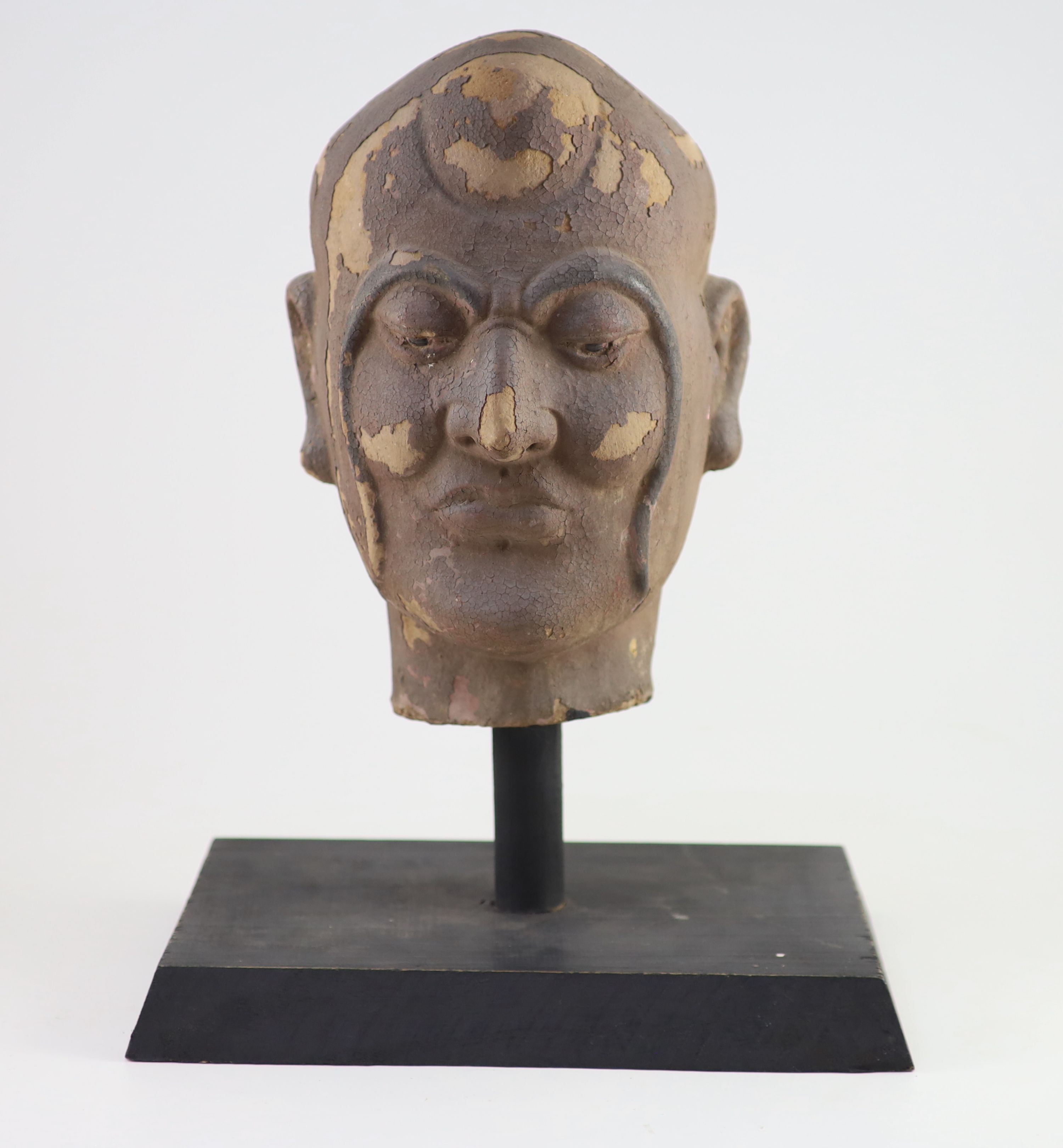 A Chinese stucco head of a luohan, Yuan-Ming dynasty, 32 cm high excluding later stand